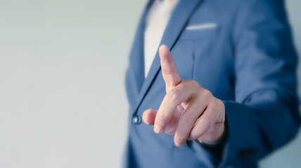 close up of businessman hand pointing for direction to success. Business and financial concept.
