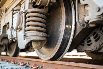 Heavy steel of train wheel on the track, transportation equipment. Close-up and selective focus on...