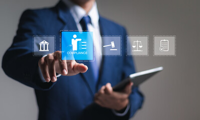 Compliance in business concept. Businessman touch compliance icon on virtual screen, ensuring the enforcement of laws, regulations, and standards. Stay in line with business policies.