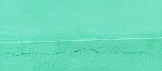 The texture of the cement wall faded green paint