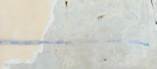 The texture of the cement wall is faded gray paint