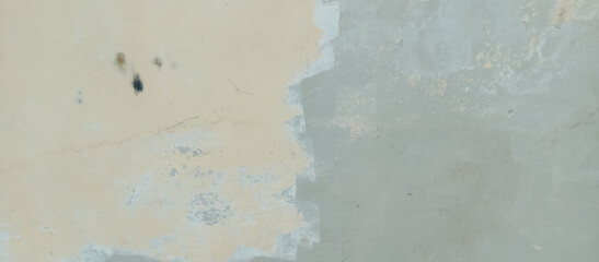 The texture of the cement wall is faded gray paint