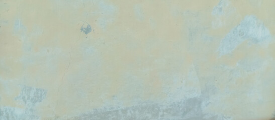 The texture of the cement wall is faded gray paint