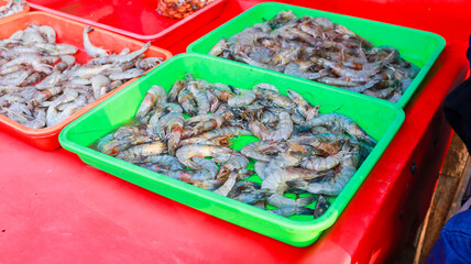 Piles of fresh sea shrimp with various sizes caught by fishermen are on display for sale at the...