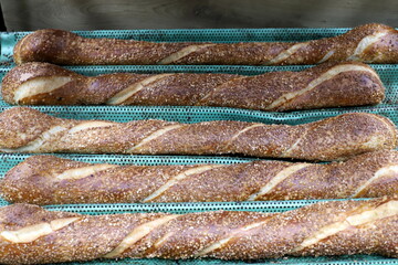 Bread and bakery products lie on display in a store.