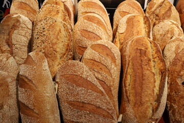 Bread and bakery products lie on display in a store.