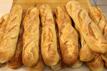 Bread and bakery products lie on display in a store.