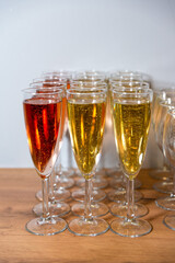 Champagne and Rose Sparkling Wine Glasses. Rows of champagne and rose sparkling wine glasses on a wooden table, ready for a celebratory toast.