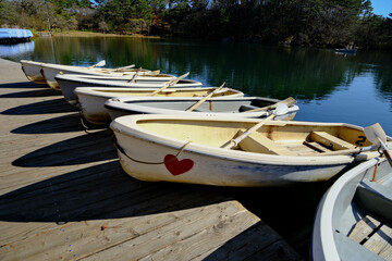 White wooden boat with red heart in Japan lake.