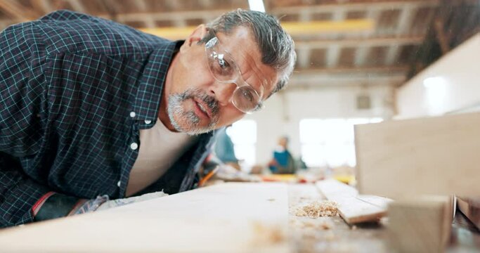Man, woodwork and blow sawdust in workshop for furniture manufacturing for small business, creativity or carpentry. Male person, plank and remodeling or lumber industry for production, hobby or diy