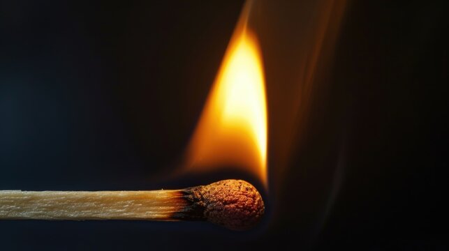 A burning match on a black background
