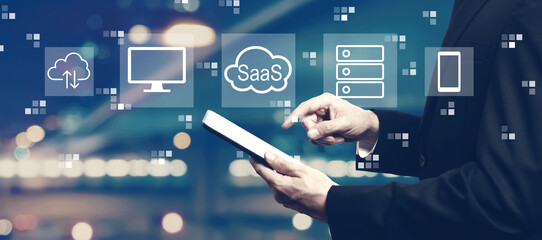 SaaS - software as a service concept with businessman using a tablet computer