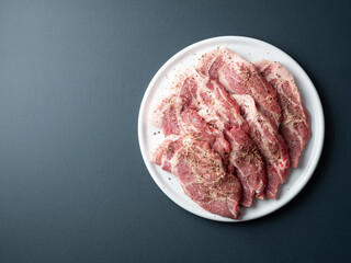 Seasoned raw pork shoulder on plate