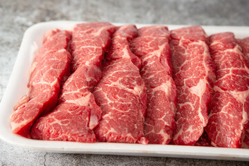 Sliced raw meat on dark background	