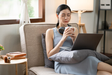 Asian woman doing activities, reading books, shopping online order through the internet at home or...