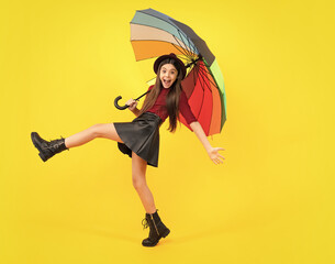 Fashion autumn kids weather. Child teenager girl with umbrella in autumn black leather skirt boots...