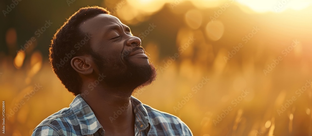 Wall mural Grateful African American man thanking God for support and care.