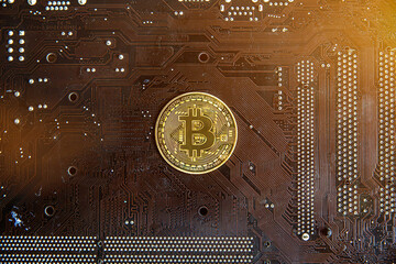 Gold souvenir coin Bitcoin on a computer circuit board background.