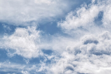 Fototapeta premium White fluffy cloud with blue sky background. Cumulus cloudscape background. Dramatic sky. Beautiful nature. Rainy season.