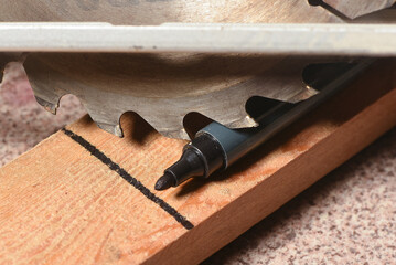 Circular saw and wooden boards close up background. Front view. Woodwork.