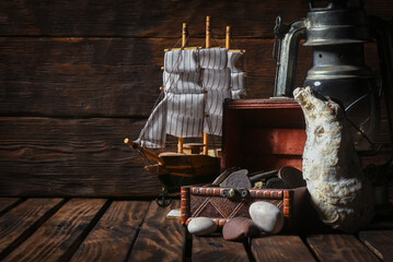 Pirate concept background front view. Sea ship, treasure chest with a coins on the wooden desk...