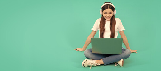 teen influencer blogging. happy girl in headphones. webinar in wireless headset. modern education. School girl portrait with laptop, horizontal poster. Banner header with copy space.