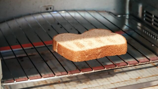 Flipping bread in a toaster oven 