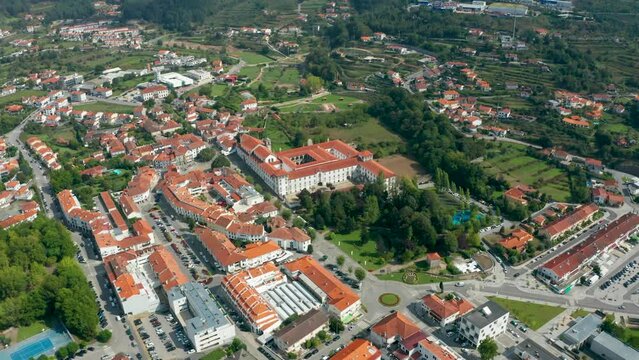 An aerial view capturing 'Santa Mafalda de Arouca Monastery' and the surrounding town in Aveiro, a district in Portugal, taken with a drone.