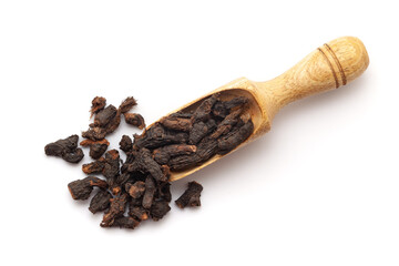 Top view of Organic Nagarmotha (Cyperus scariosus) roots, in a wooden scoop. Isolated on a white background.