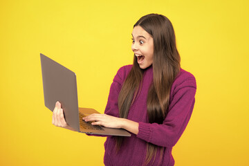 Excited face. Young student school girl, studying with laptop computer. E-learning concept. Amazed expression, cheerful and glad.