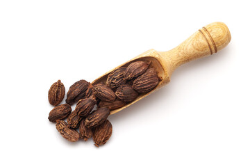 Top view of Organic Black cardamom (Amomum subulatum), in a wooden scoop. Isolated on a white background.