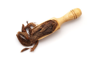 Top view of Organic Jatamansi (Nardostachys jatamansi) roots, in a wooden scoop. Isolated on a white background.