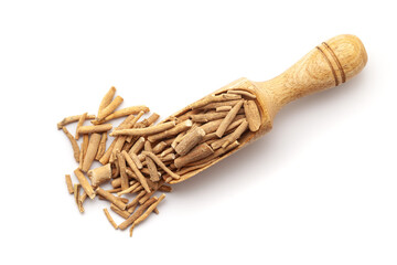 Top view of Organic Dry Ashwagandha (Withania somnifera) roots, in a wooden scoop. Isolated on a...