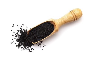 Top view of Organic black cumin  (Nigella sativa) or kalonji in a wooden scoop. Isolated on a white background.