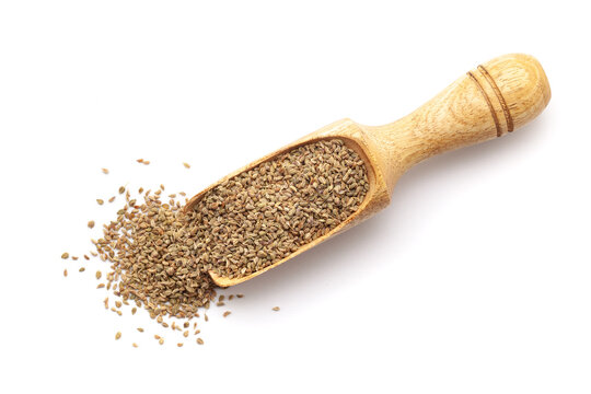 Top view of Organic Carom seeds (Trachyspermum ammi) or Ajwain in a wooden scoop. Isolated on a white background.