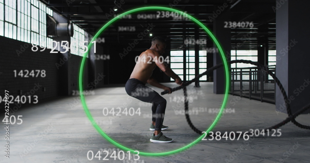 Poster image of green circle and floating numbers over man exercising with ropes