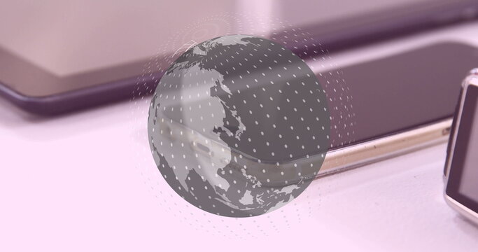 Image of globe over tablet, smartphone and smartwatch - Powered by Adobe