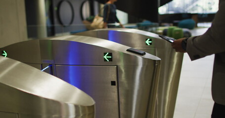 African American businessman at office turnstiles, with copy space