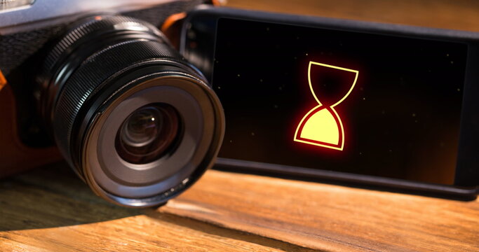 Image of data processing with hourglass icon on smartphone screen