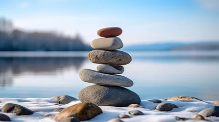 Türaufkleber Steine ​​im Sand Pebbles or stones balanced on snowy ground. Concept of harmony, meditation, and wellness in winter.