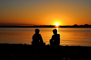 Fototapeta na wymiar two silhouettes against sunset, on a quiet beach