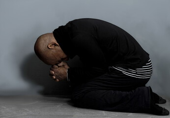 man praying in poverty on the floor stock image with no help crying alone and all by himself on...