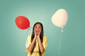 Valentines day and kids concept. Teenage girl in yellow dress with red heart-shaped balloon over...