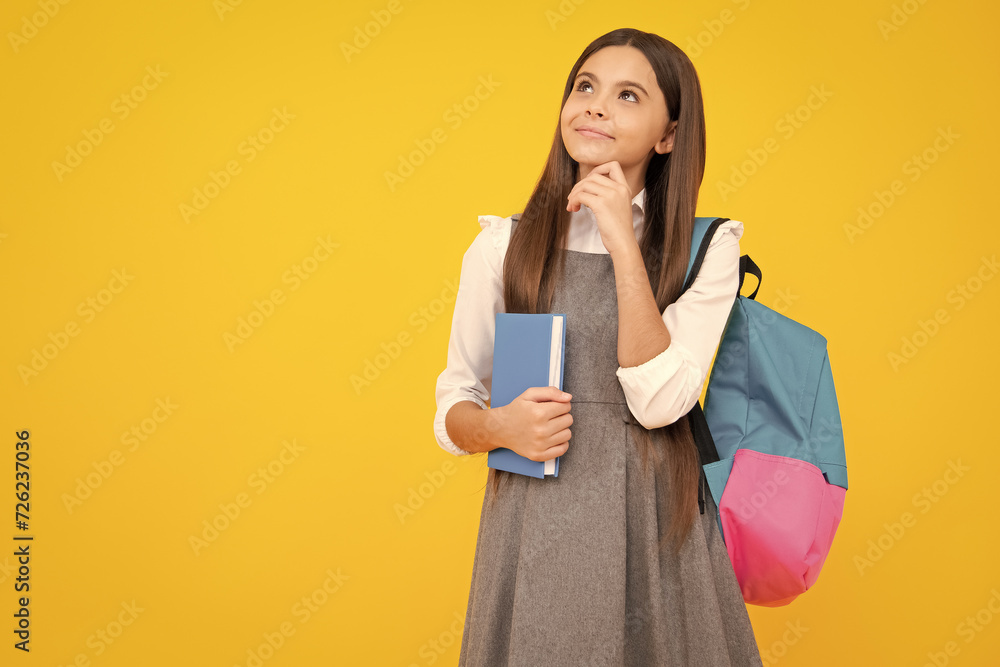 Poster schoolgirl, teenage student girl hold book on yellow isolated studio background. school and educatio