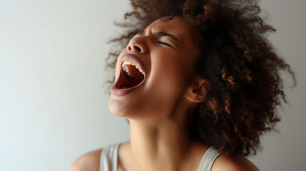 Joyful woman singing loudly with eyes closed.