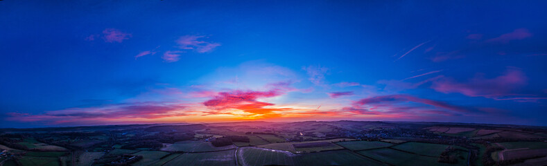 Aerial panorama of stunning sunset over English countryside