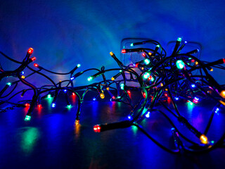 chains of light on a dark blue background resemble a starry sky at night. display stand with...