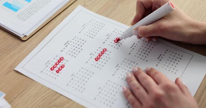 Calendar page and closeup of woman hand counting down days on weekly calendar in office