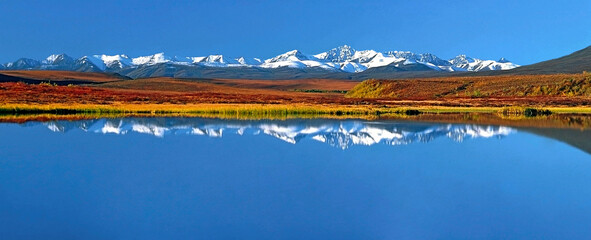 Spectacular Dempster Highway Mountain Scenery with reflection in water, Yukon, Canada.