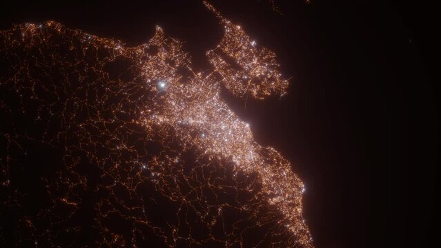 Cebu City (Philippines) aerial view at night. Top view on modern city with street lights. Camera is zooming out, rotating counterclockwise. Vertical video. The north is on the left side